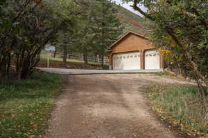 View of front of house featuring a garage, an outbuilding, and a mountain view