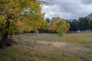 View of yard featuring a rural view and a mountain view