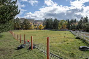 View of yard featuring a rural view and a mountain view