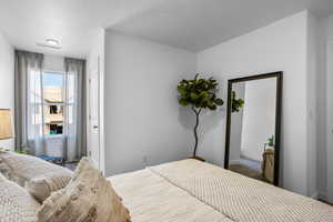 Bedroom featuring a textured ceiling and dark colored carpet