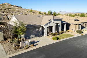 View of front facade with a garage and a mountain view