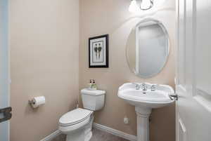 Bathroom featuring toilet and tile patterned flooring