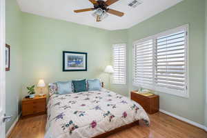 Bedroom with ceiling fan and light hardwood / wood-style flooring