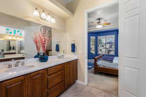 Bathroom featuring tile patterned flooring, ceiling fan, and vanity