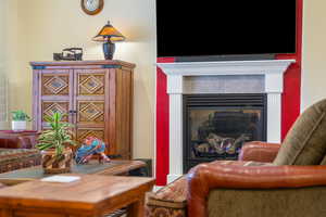 Living room featuring a tile fireplace