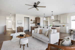 Living room featuring ceiling fan, light hardwood / wood-style floors, and sink