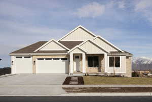 View of front of home with a garage and a mountain view