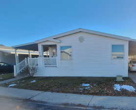 View of side of home with a porch