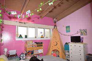 Bedroom with wood ceiling and beamed ceiling