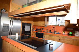 Kitchen with black appliances and sink