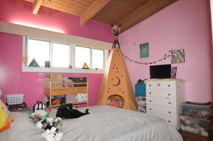 Bedroom featuring beam ceiling and wood ceiling