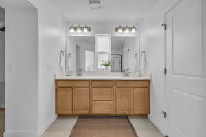 Bathroom featuring vanity and tile patterned floors