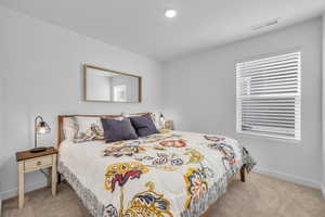 Bedroom with light colored carpet