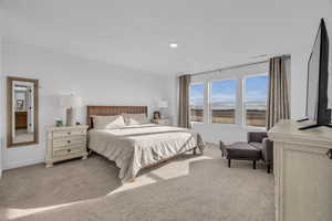 Bedroom featuring light colored carpet