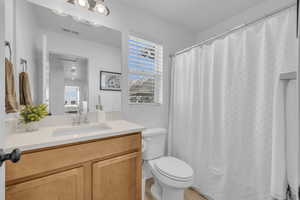 Bathroom featuring vanity and toilet