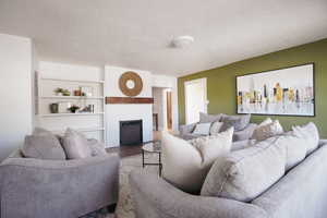 Living room with wood-type flooring and a textured ceiling