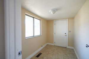 Doorway with a textured ceiling