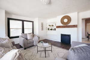 Living room with built in shelves and hardwood / wood-style flooring