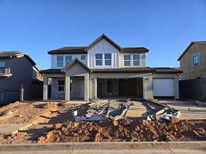 View of front of home featuring covered porch and a garage