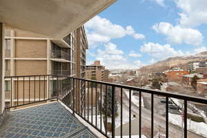 Snow covered back of property featuring a mountain view