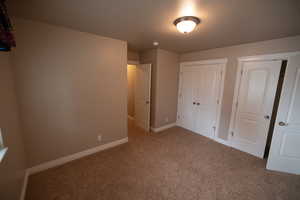 Unfurnished bedroom with carpet