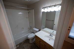 Full bathroom featuring toilet, shower / bath combination, and vanity