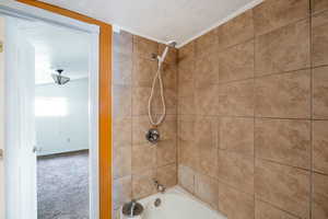 Bathroom featuring tiled shower / bath combo