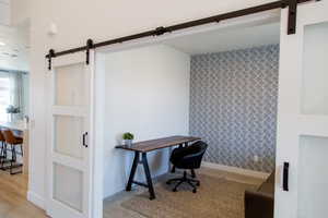 Office near the front door with glass barn doors