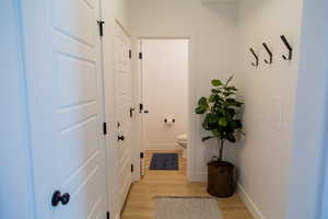 Doorway to garage, under stair closet and half bath