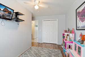 Game room with hardwood / wood-style flooring and ceiling fan