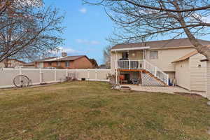 Rear view of property featuring a patio area and a lawn