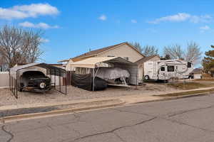 View of front of property with a carport