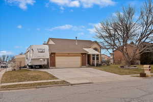 View of front of property with a front lawn and a garage