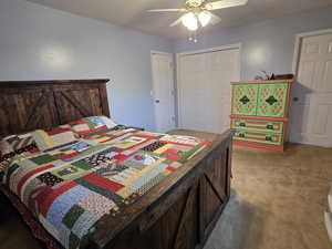 Bedroom with carpet flooring, a closet, and ceiling fan