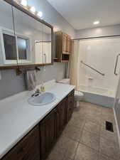 Full bathroom featuring toilet, vanity, and shower / bath combo