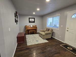 Interior space with dark hardwood / wood-style flooring