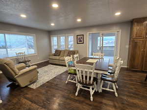 Dining room featuring a textured ceiling and dark hardwood / wood-style floors