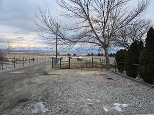 View of yard with a rural view and a mountain view