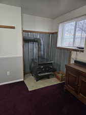 Bathroom featuring wood walls and a wood stove