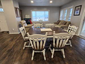 Dining area with dark wood-type flooring