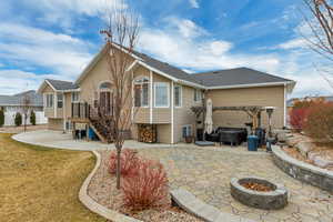 Back of house with a patio area, a yard, a fire pit, and a pergola