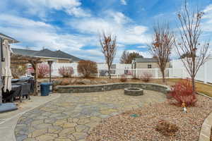 View of patio with an outdoor fire pit