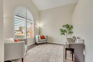 Living area featuring hardwood / wood-style floors and lofted ceiling