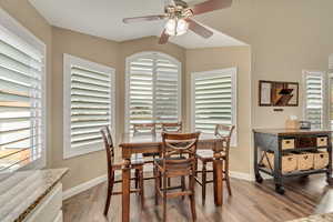 Dining space featuring hardwood / wood-style flooring, ceiling fan, and lofted ceiling