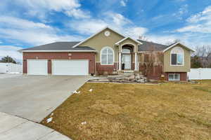 View of front of house featuring a front yard and a garage