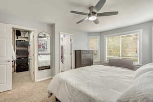 Carpeted bedroom with ceiling fan