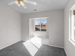 Carpeted empty room with ceiling fan