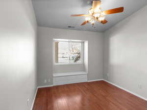 Spare room with ceiling fan and hardwood / wood-style flooring