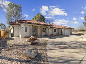 Mediterranean / spanish house featuring a garage