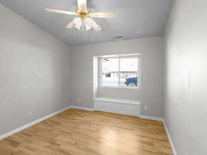 Empty room featuring light wood-type flooring and ceiling fan